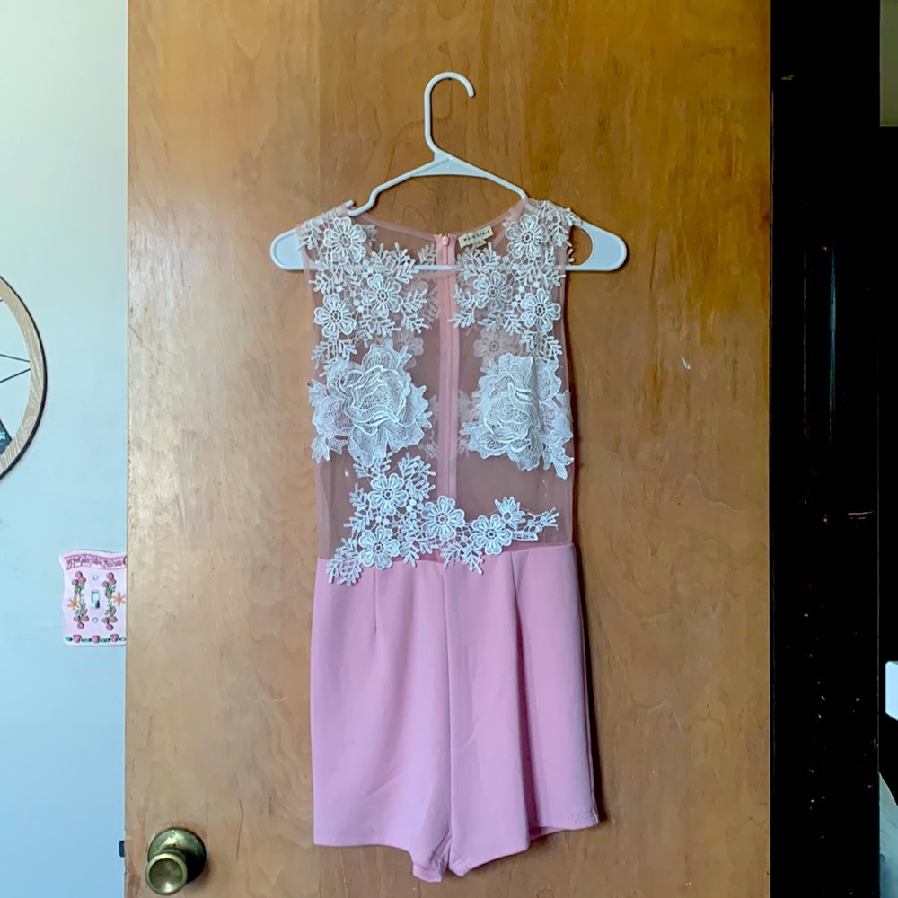 One-piece with zipper. Fits very well and shows off curves